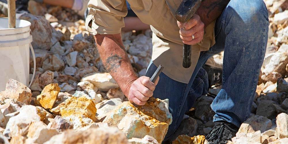 man mining turquoise at otteson brothers