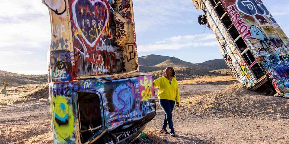 woman exploring international car forest in nevada