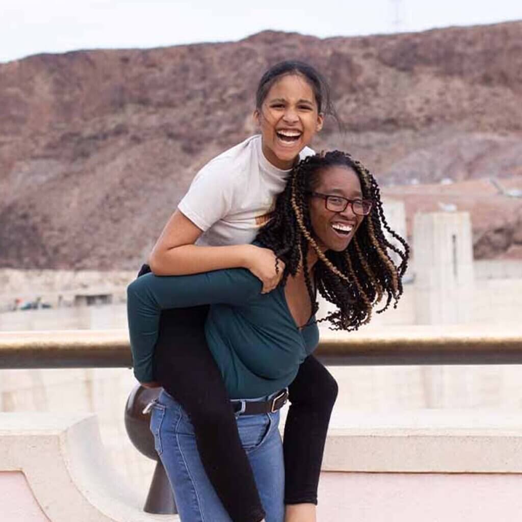 friends walking across hoover dam