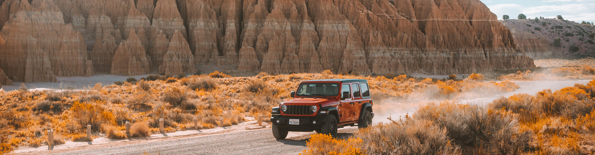 a jeep driving on a dirt road at cathedral gorge state park in panaca nevada