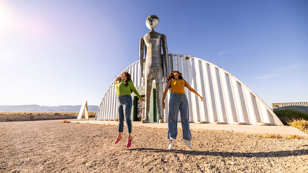 two women jumping outside the alien research center in hiko nevada on the extraterrestrial highway