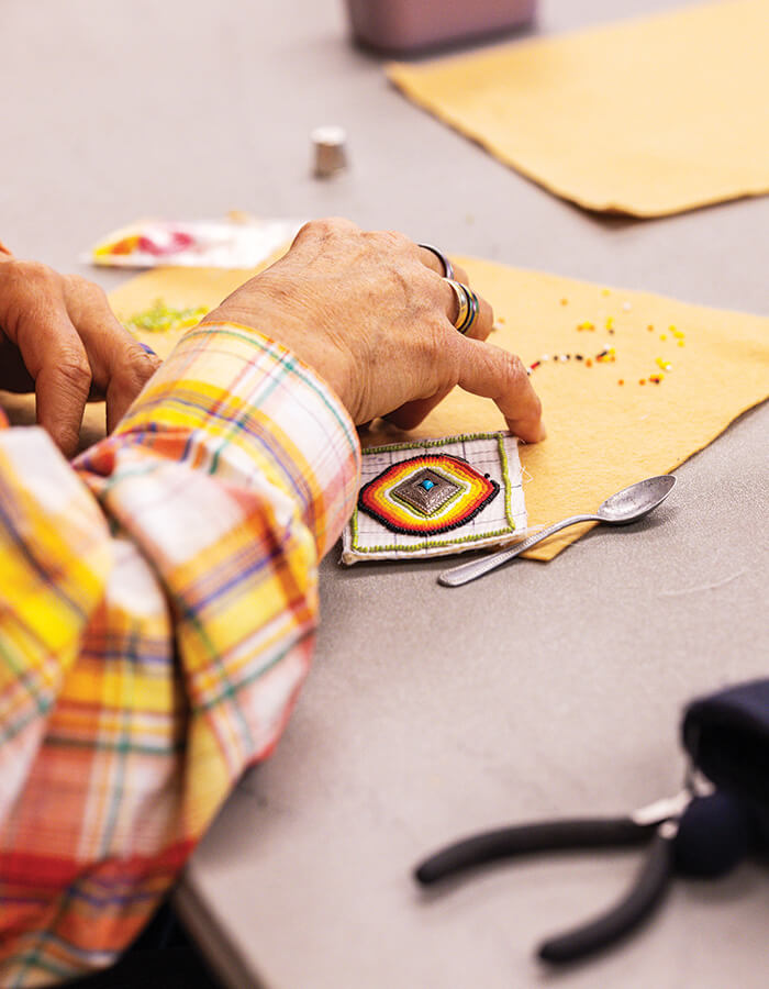 Hands working on beading at Cowboy Poetry in Elko
