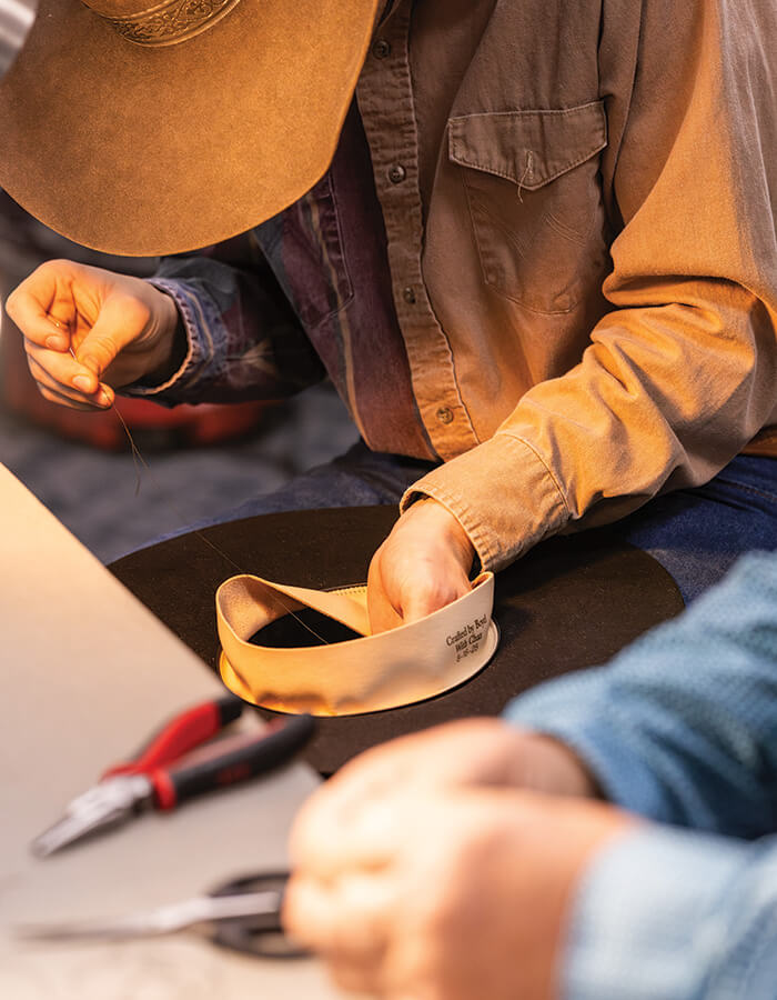 Hands working on a hat at Cowboy Poetry in Elko