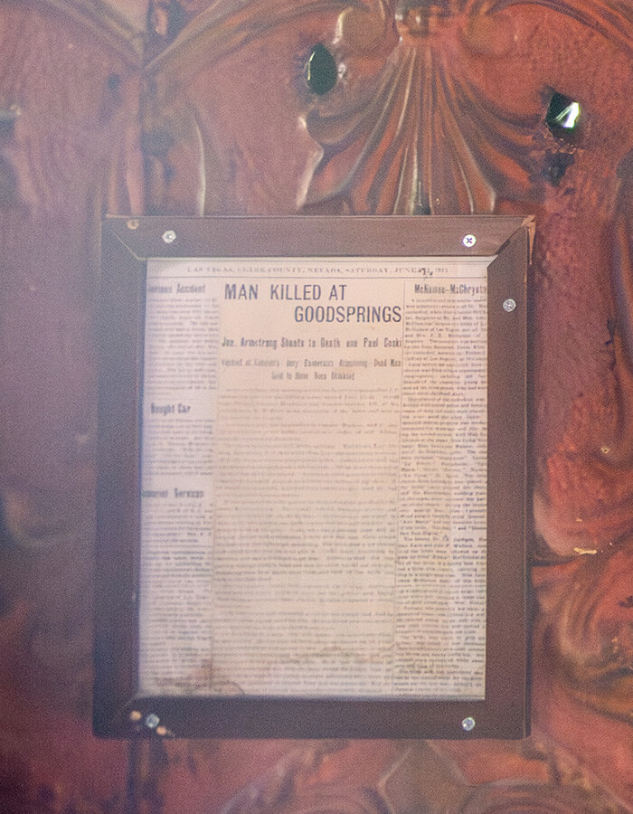 Bullet holes in the walls of the Pioneer Saloon along with a story about a murder in a 1915 newspaper
