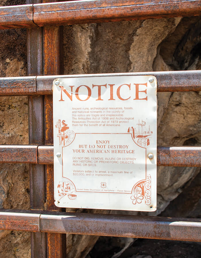 a sign posted on a fence