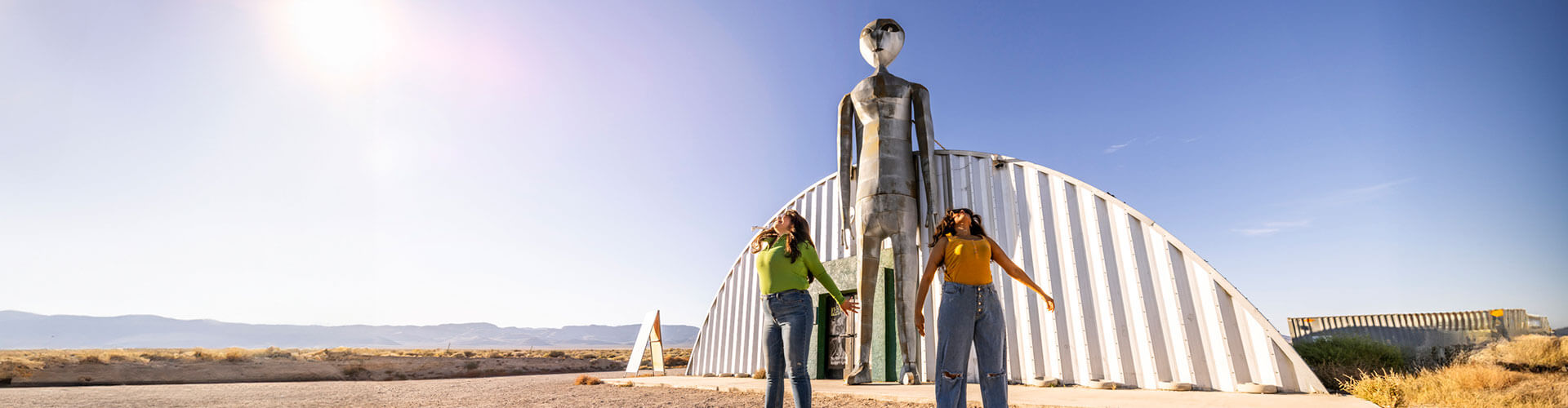 two women jumping outside the alien research center in hiko nevada on the extraterrestrial highway