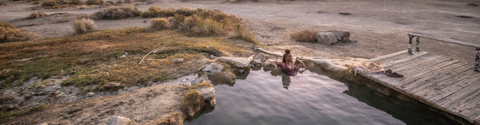 a woman soaking solo at spencer hot springs in nevada