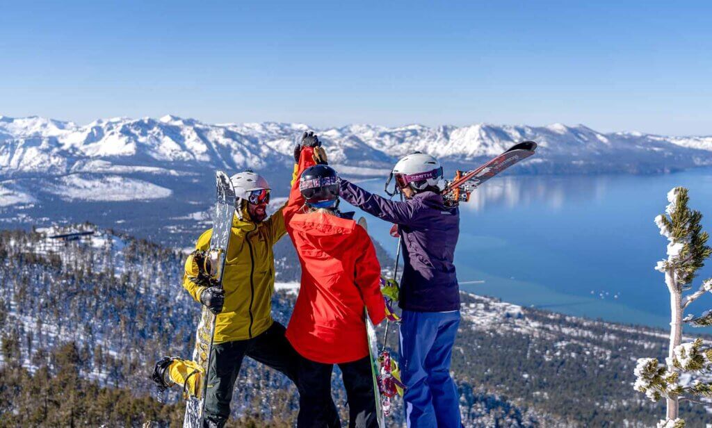 skiiers atop lake tahoe ski resort mountain