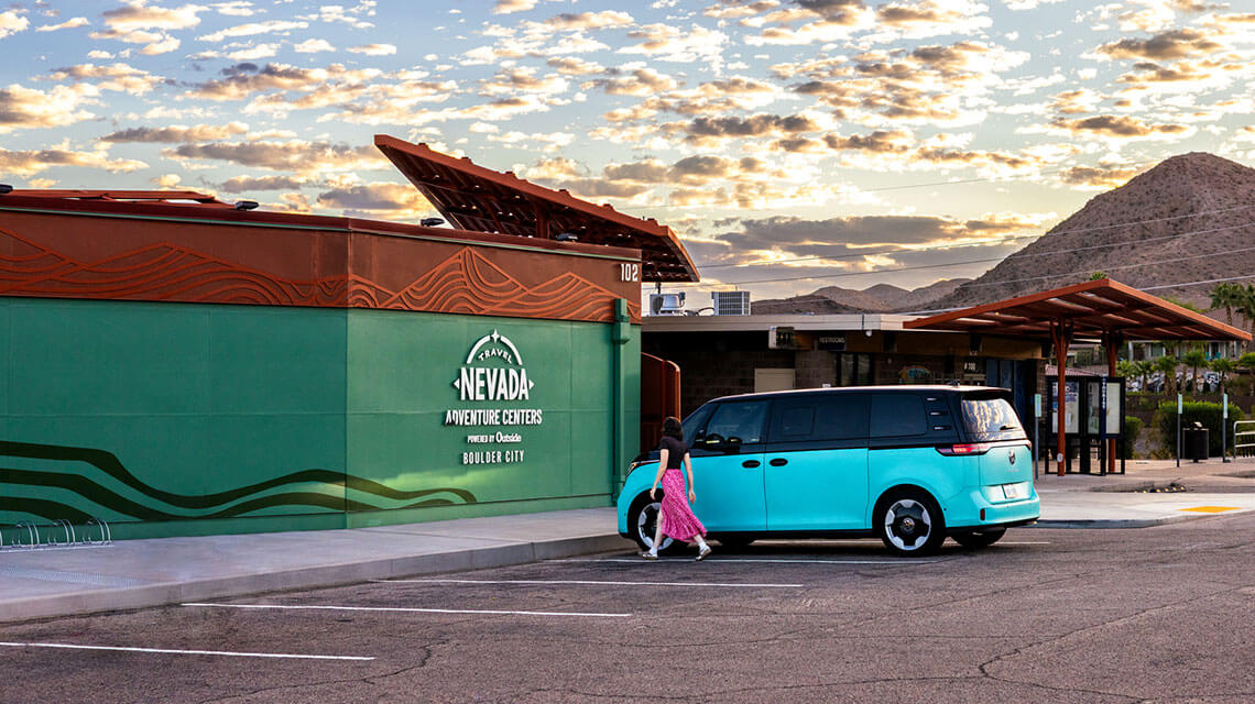 woman outside the travel nevada adventure center powered by outside boulder city in boulder city nv